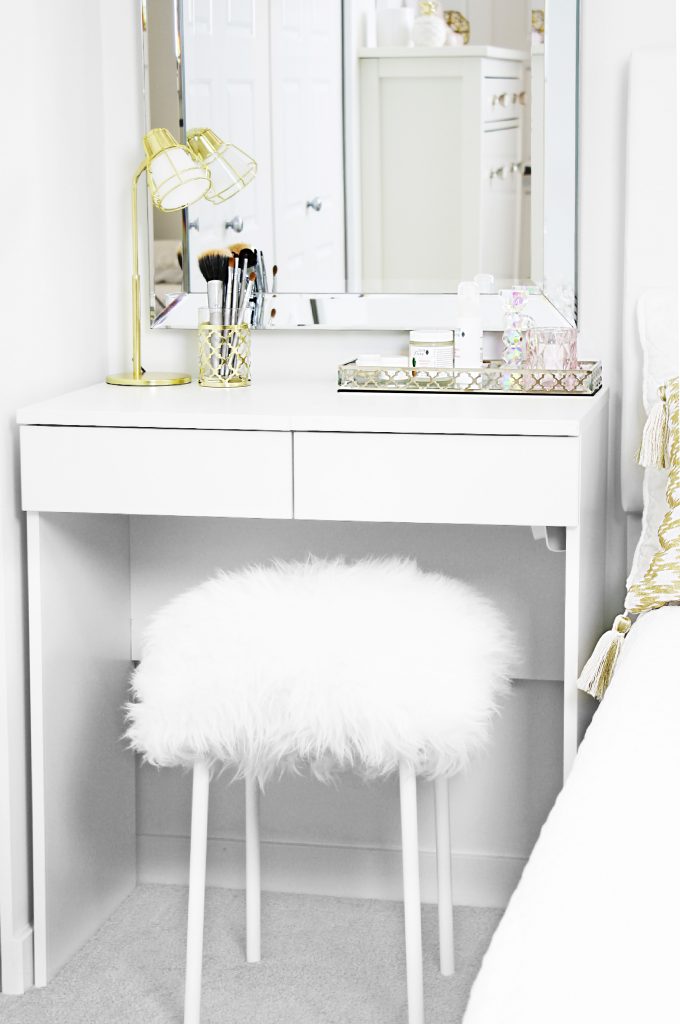 DIY fuzzy stool pictured underneath a white dressing table in girl's bedroom
