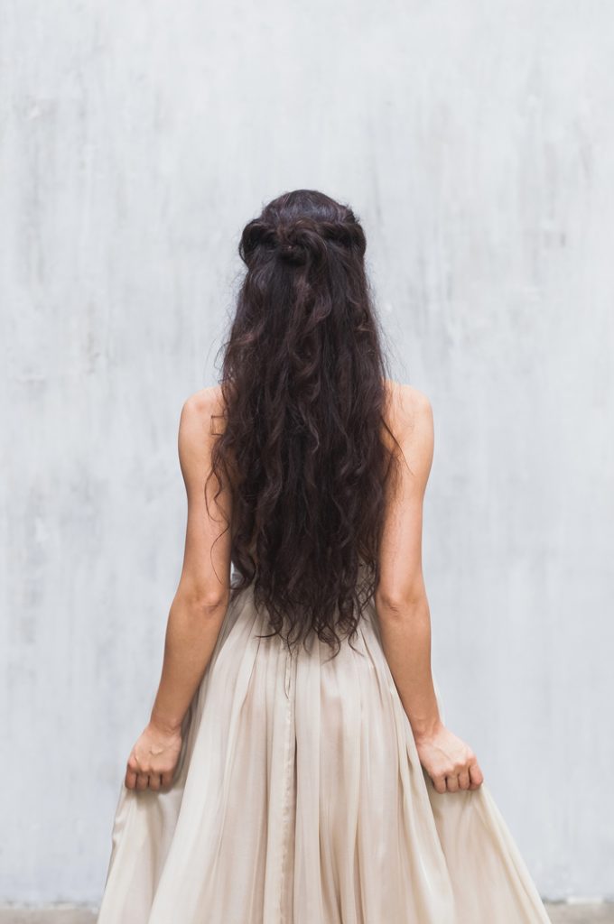 Woman in white dress with beautiful, flowing brown hair